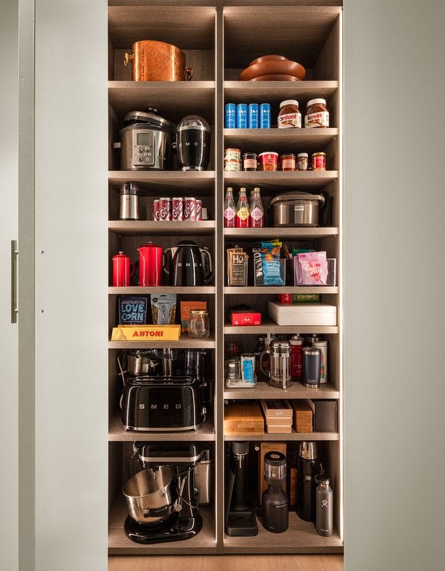 Antoni Porowski’s custom kitchen pantry cabinet storage in wood grain finish by California Closets