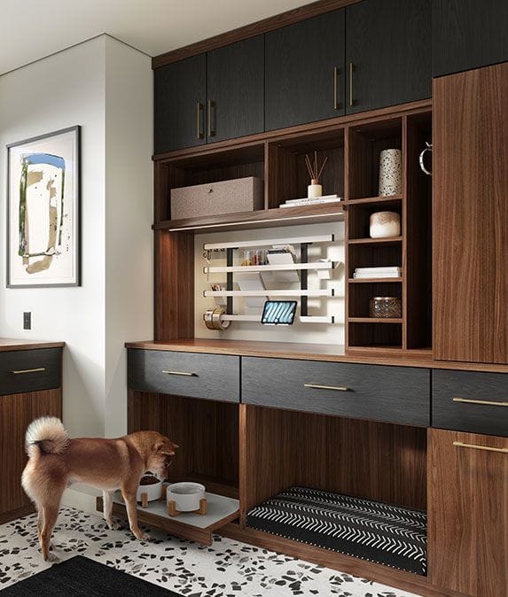 Pet care station and bed beneath custom cabinets for storage by California Closets