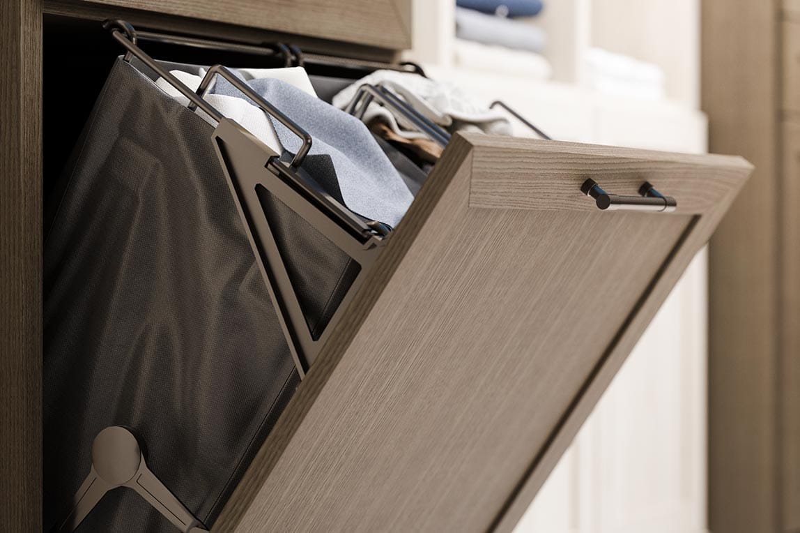 Custom design built in tilt-out hamper for laundry room with removable bag designed by California Closets