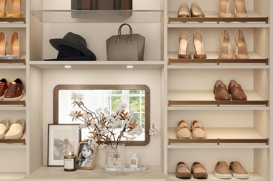 Puck lighting, titled shoe storage, and glass shelving details by California Closets