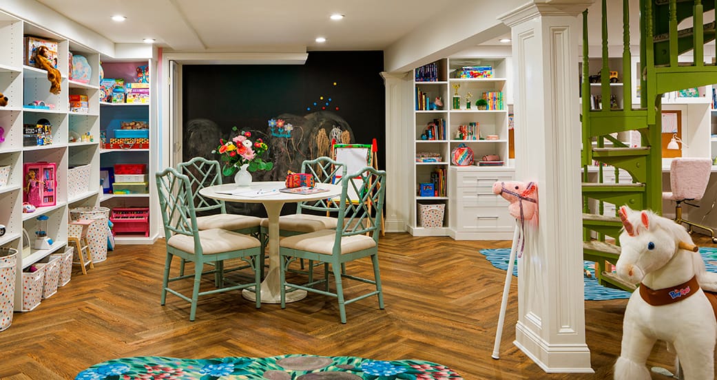 Family playroom with round table, organized shelving and playful details, custom storage by California Closets