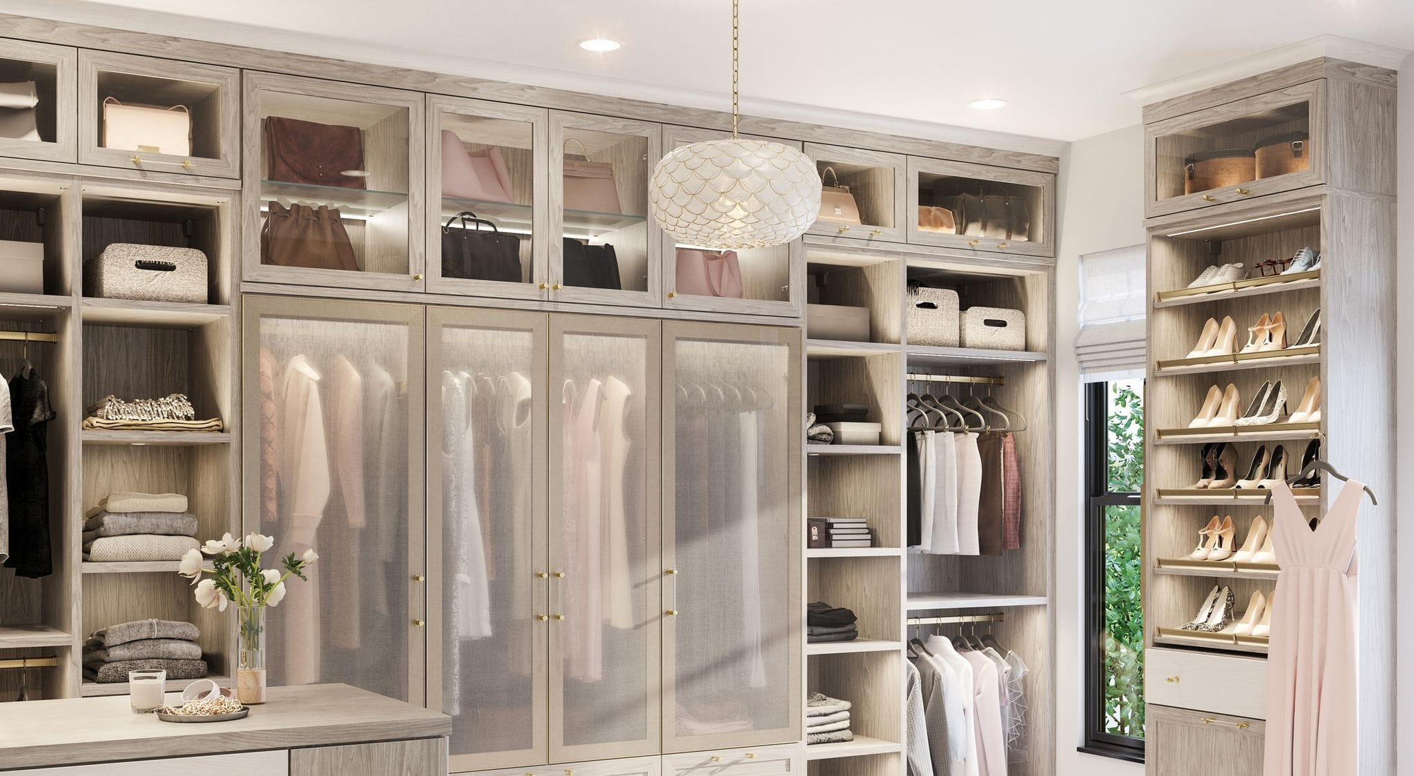 Walk in closet designed with decorative cabinet doors, vanity and desk by California Closets