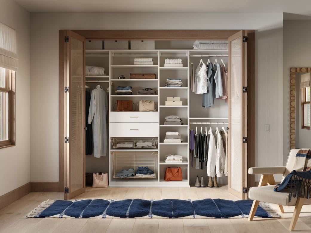 Reach in design open shelving, custom closet doors, short and long hanging wardrobe poles and closet organizers by California Closets