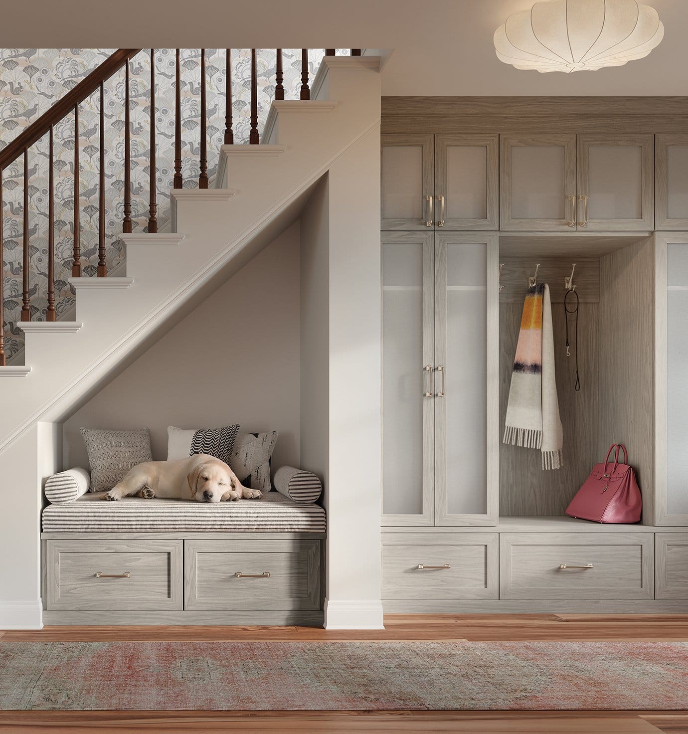 Entryway storage system with a bench, built in drawers, and light grain cabinets by California Closets
