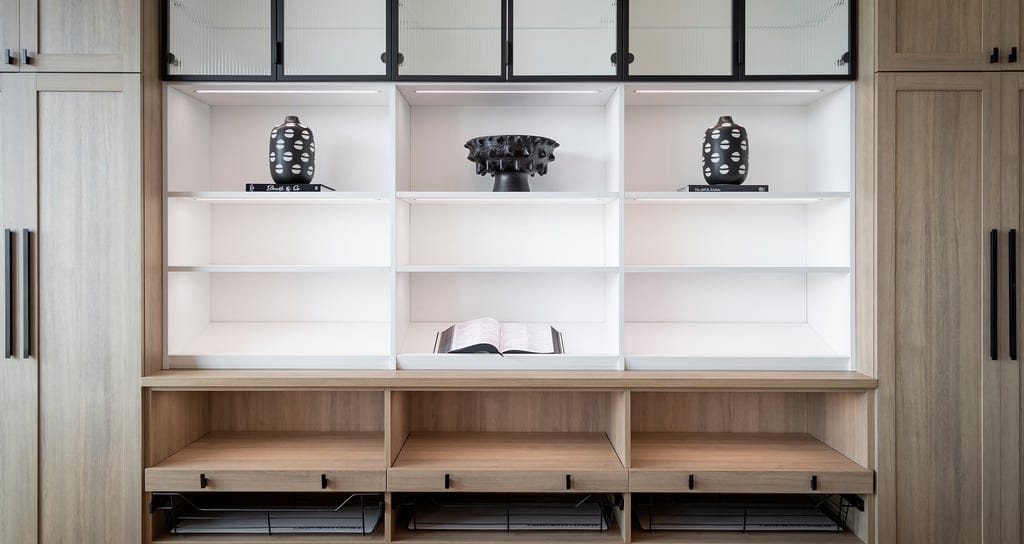 Custom lighted built in shelving system for living room from California Closets